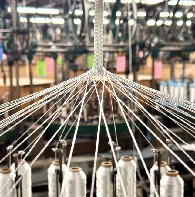 A loom with a spool of thread hanging from it. AI generated content