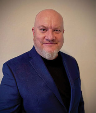 A man wearing a blue suit and a black shirt is smiling for the camera. AI generated content