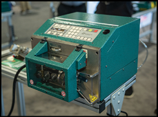 A green machine with a digital screen. Description generated by AI