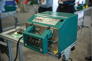 A green machine with a digital display. Description generated by AI