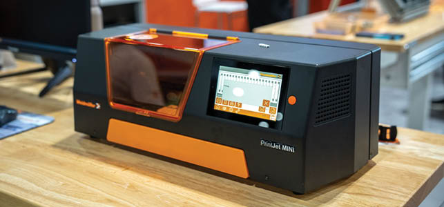 A black and orange machine with a screen on it. Description generated by AI