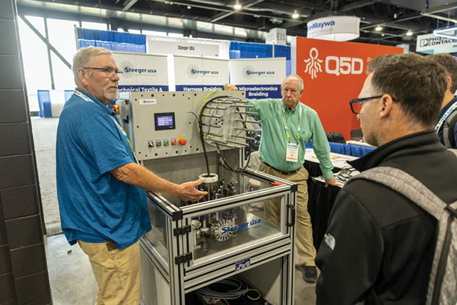 A man in a blue shirt is operating a machine. Description generated by AI