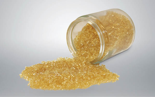 A glass container with yellow substance in it. Description generated by AI