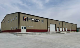 A large building with a red and white sign on the side. Description generated by AI