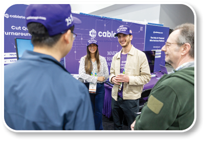 A group of people are standing in front of a purple display. Description generated by AI