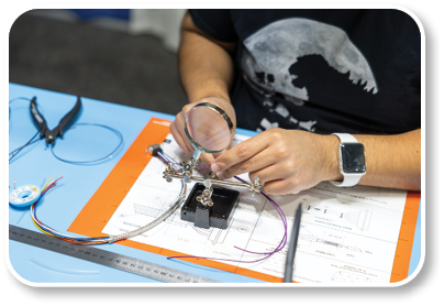 A person is working on a project at a table. Description generated by AI