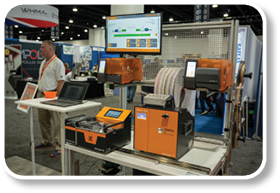 A display of machines and a man in a white shirt. Description generated by AI