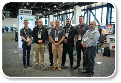A group of men wearing name tags and shirts. Description generated by AI