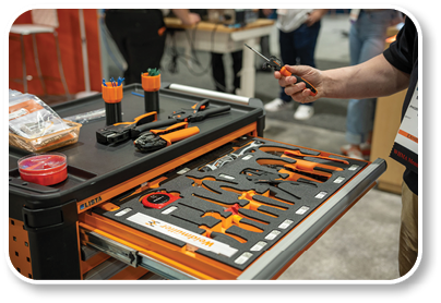 A man is working on a table with various tools. Description generated by AI