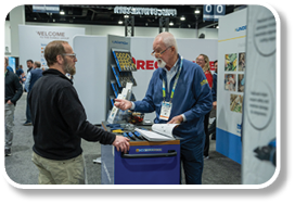 A man is showing a display to another man. Description generated by AI
