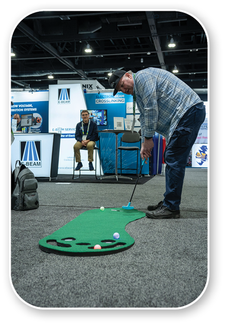A man is playing golf on a miniature golf course. Description generated by AI