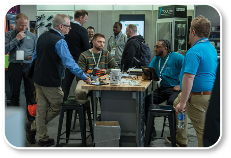 A group of people are standing around a table. Description generated by AI