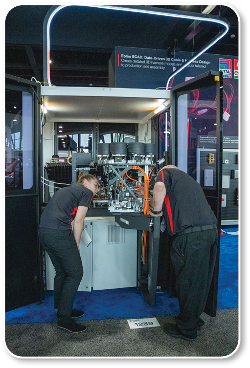 Two people working on a machine. Description generated by AI