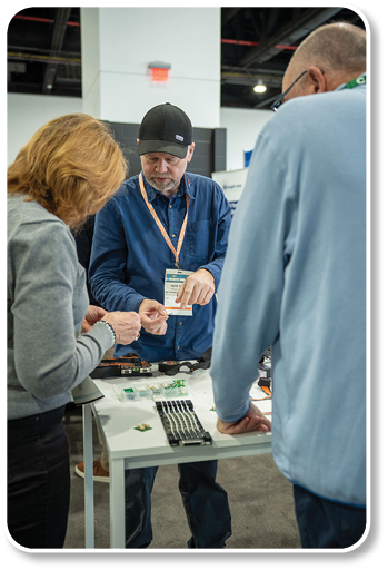 A man is fixing a small electronic device. Description generated by AI