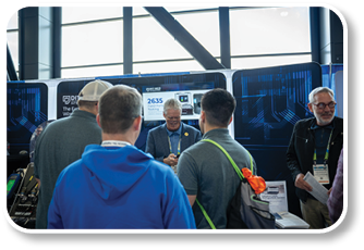 A group of people standing in front of a display. Description generated by AI