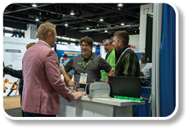 A group of men are standing around a table. Description generated by AI