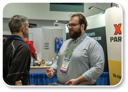 A man in a white shirt is showing another man a badge. Description generated by AI