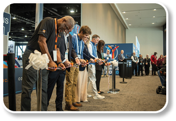 A group of people cutting ribbons with scissors. Description generated by AI